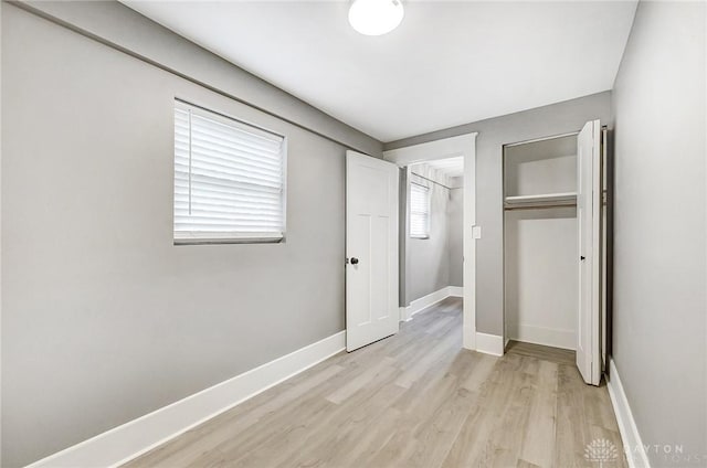 unfurnished bedroom featuring a closet and light hardwood / wood-style flooring