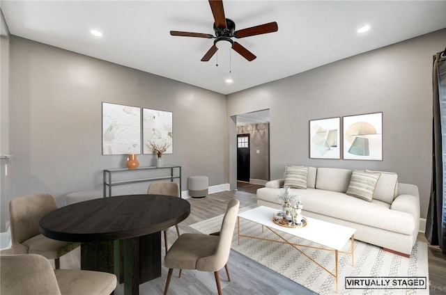 living room featuring ceiling fan and wood-type flooring