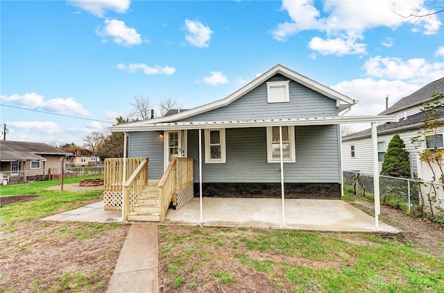 rear view of property featuring a lawn and a patio