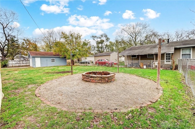 view of yard featuring an outbuilding and an outdoor fire pit