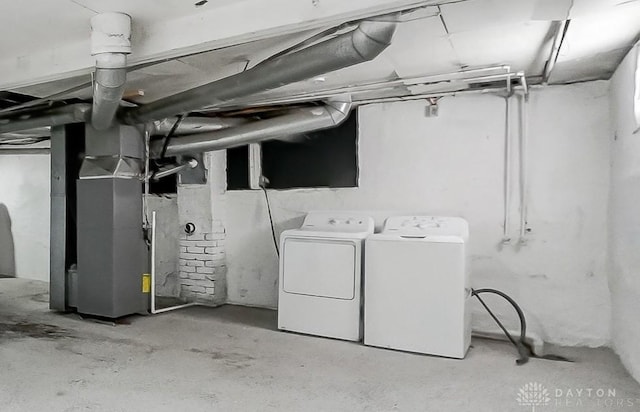 basement featuring independent washer and dryer and heating unit