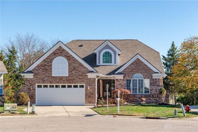 view of front of property with a front yard and a garage