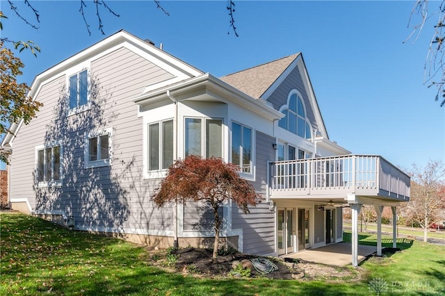 rear view of house with a patio and a lawn