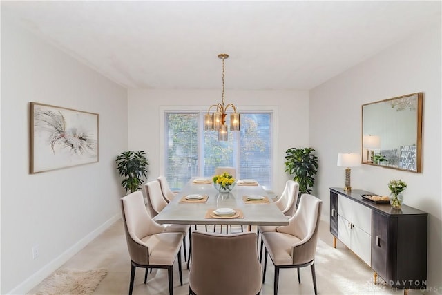 dining room featuring light tile patterned floors, a notable chandelier, and baseboards