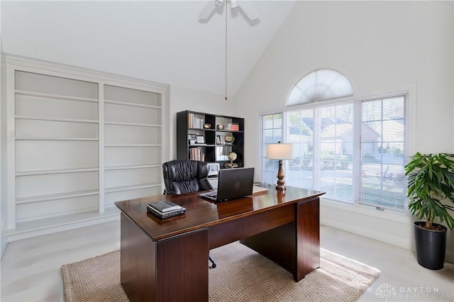 office area featuring built in shelves, high vaulted ceiling, and a ceiling fan