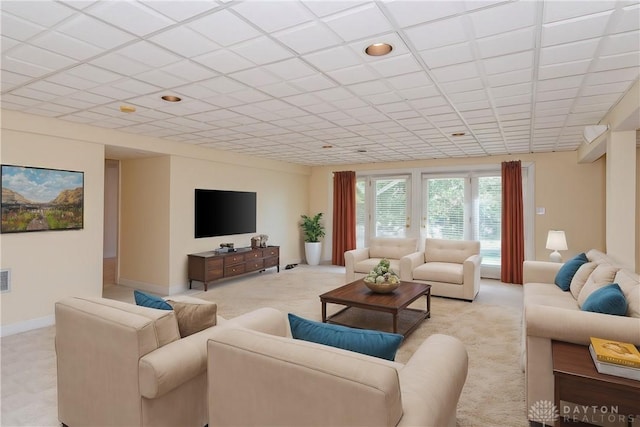 living room with baseboards and light carpet