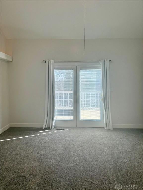 empty room with baseboards and carpet floors