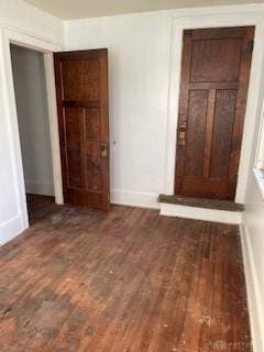 interior space with dark wood-type flooring and a closet