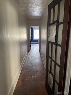 hall featuring baseboards and brick floor
