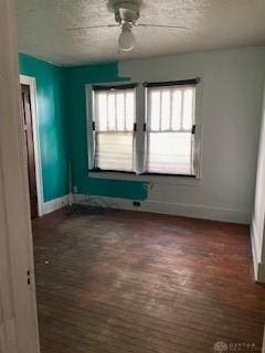 unfurnished room featuring dark hardwood / wood-style flooring and plenty of natural light