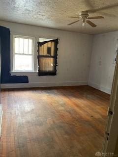 unfurnished room with ceiling fan, a textured ceiling, and hardwood / wood-style flooring