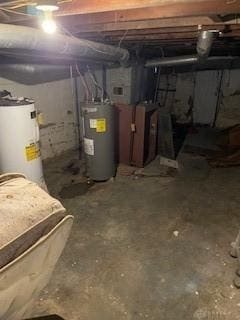 basement featuring gas water heater and electric water heater