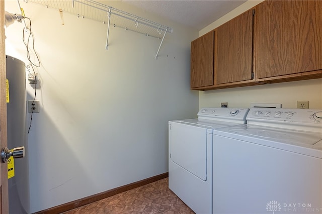 laundry area featuring washer and dryer and cabinets