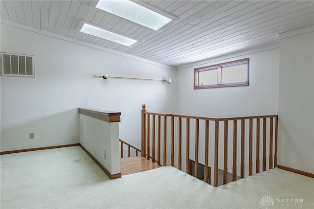 interior space featuring carpet and wood ceiling