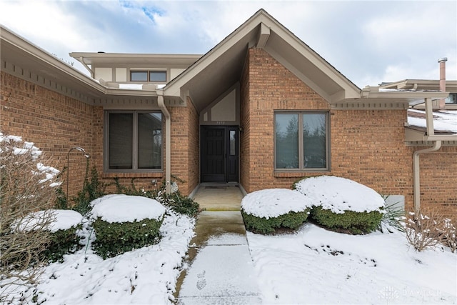 view of snow covered property entrance