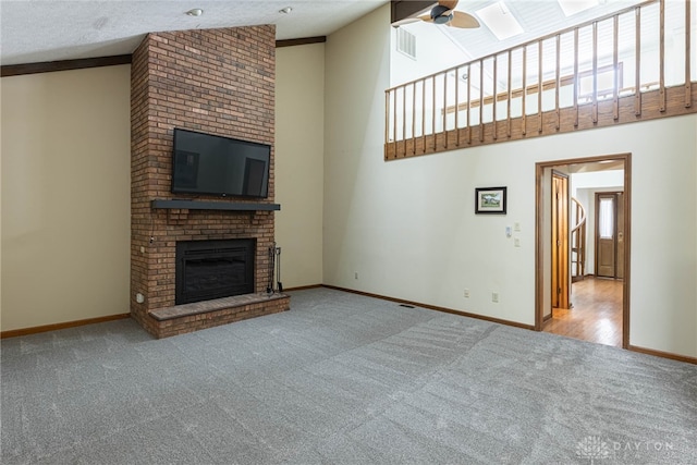 unfurnished living room with ceiling fan, light colored carpet, lofted ceiling, and a brick fireplace