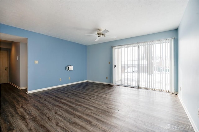 unfurnished room with ceiling fan and dark hardwood / wood-style floors