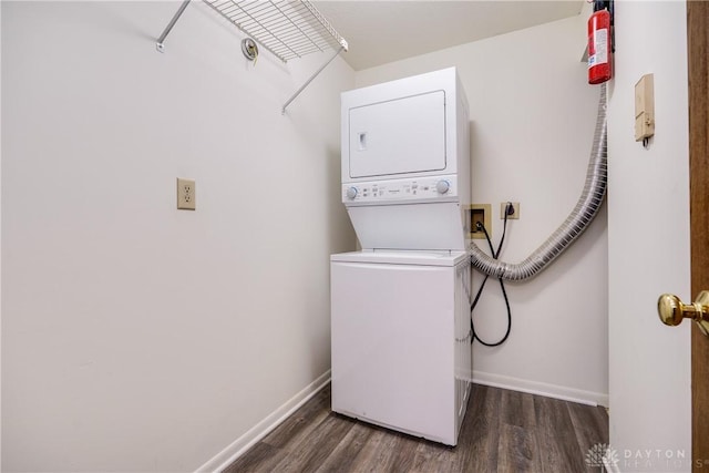 washroom featuring stacked washer / dryer and dark wood-type flooring