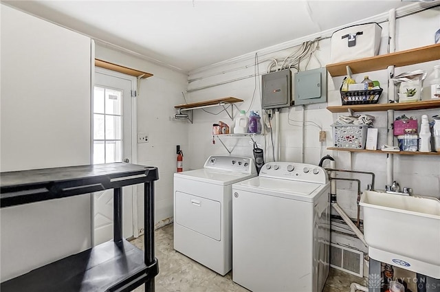 laundry area featuring independent washer and dryer and sink