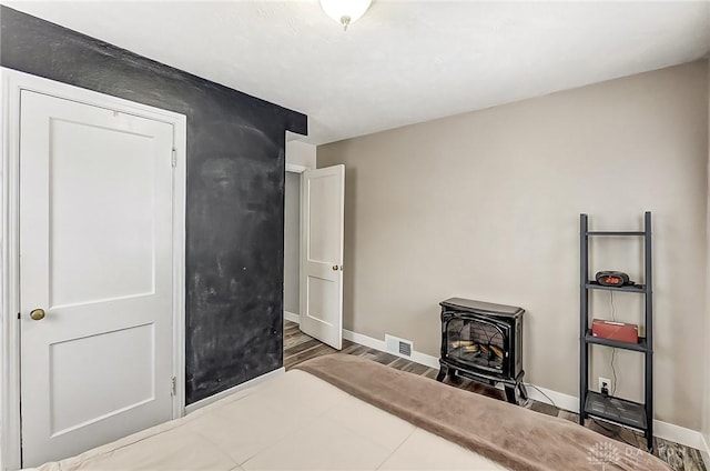 bedroom with a wood stove