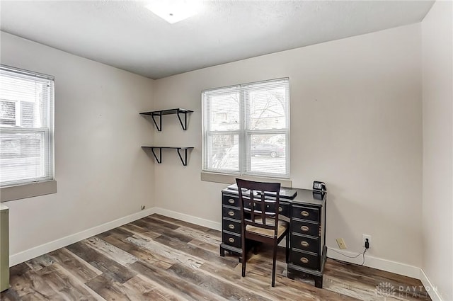 office space with wood-type flooring