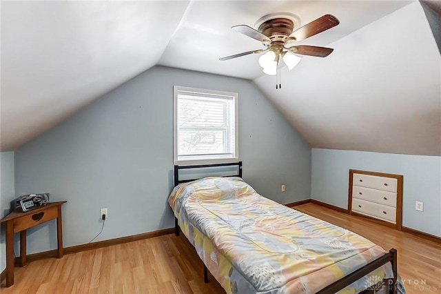 bedroom with ceiling fan, light hardwood / wood-style floors, and lofted ceiling