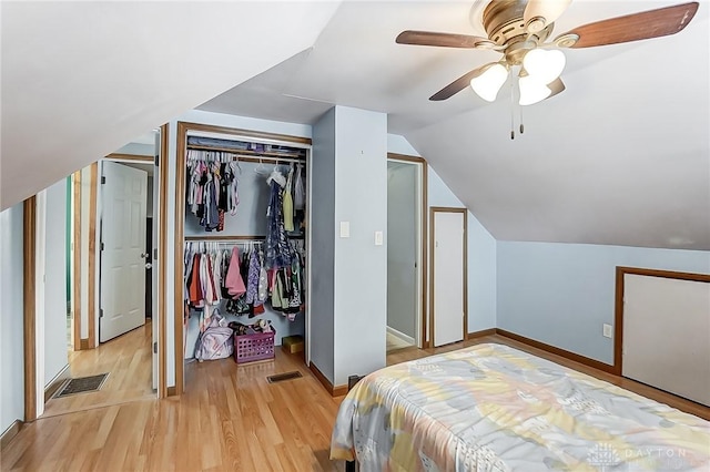 bedroom with ceiling fan, lofted ceiling, and light hardwood / wood-style flooring