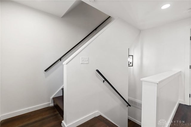 stairway with hardwood / wood-style floors