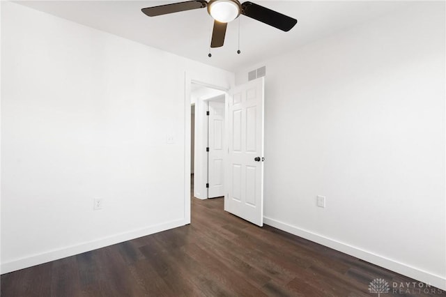 spare room with ceiling fan and dark wood-type flooring