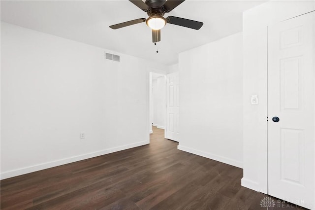 spare room featuring ceiling fan and dark hardwood / wood-style flooring