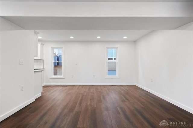 unfurnished living room featuring dark hardwood / wood-style flooring