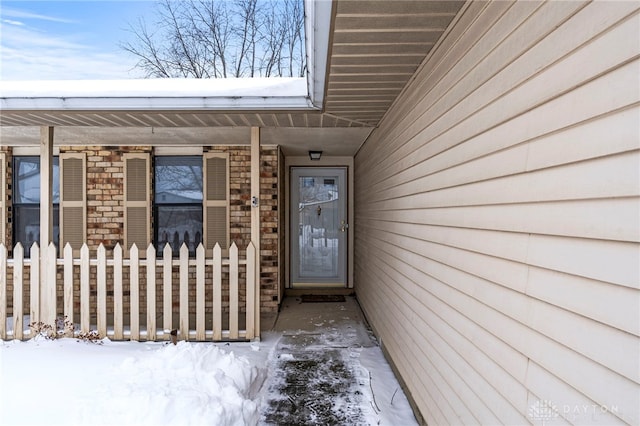 view of snow covered property entrance