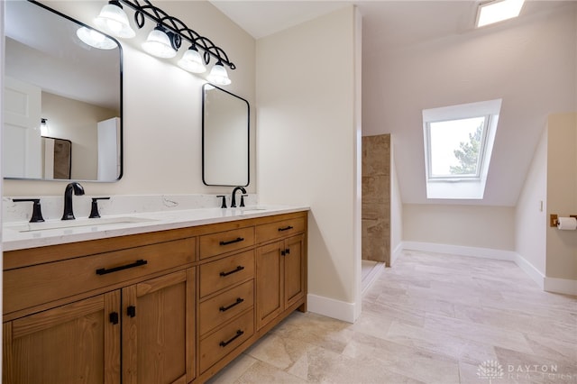 bathroom with vanity, walk in shower, and a skylight