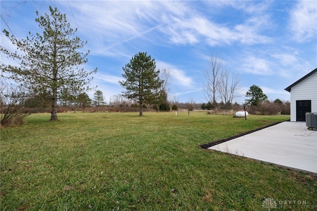 view of yard featuring central AC and a patio