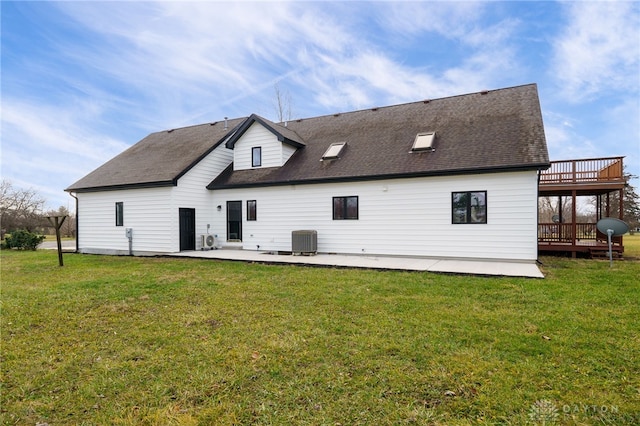 rear view of property featuring a lawn, cooling unit, a patio, and a deck