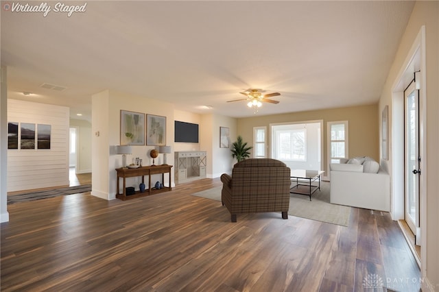 living room featuring dark hardwood / wood-style floors and ceiling fan