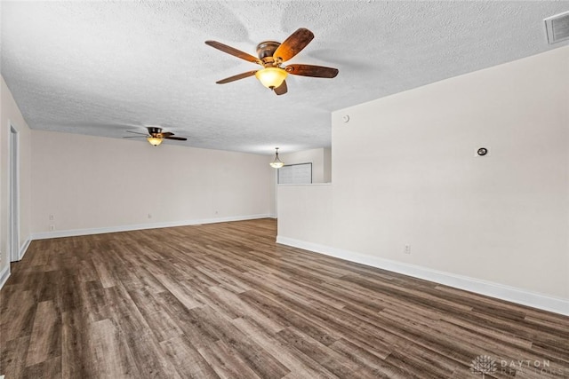 unfurnished room with dark hardwood / wood-style flooring and a textured ceiling