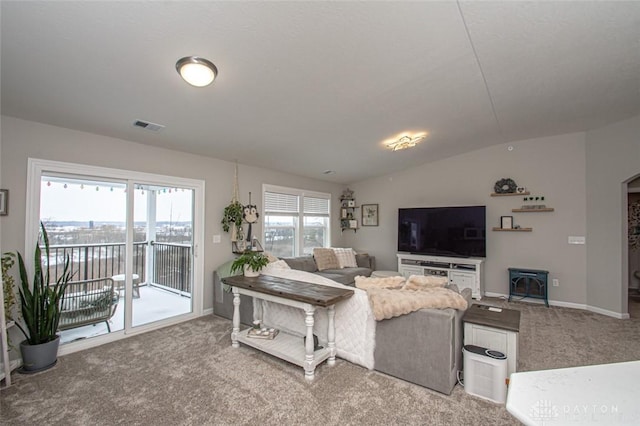 carpeted living room featuring vaulted ceiling