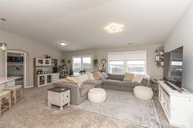 living room featuring light colored carpet and lofted ceiling