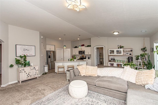 carpeted living room with lofted ceiling