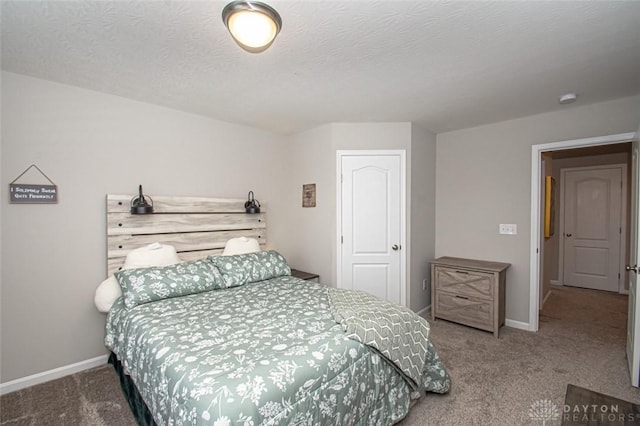 carpeted bedroom featuring a textured ceiling