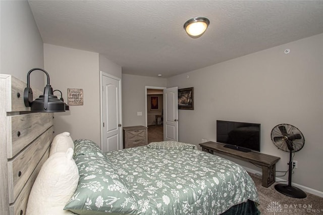 bedroom featuring carpet flooring and a textured ceiling