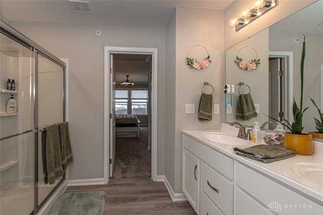 bathroom featuring a shower with door, vanity, and hardwood / wood-style floors