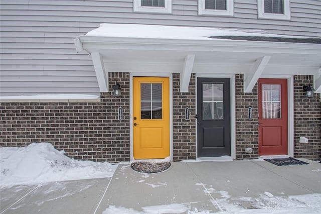 view of snow covered property entrance