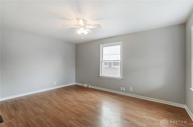 spare room with light hardwood / wood-style floors and ceiling fan