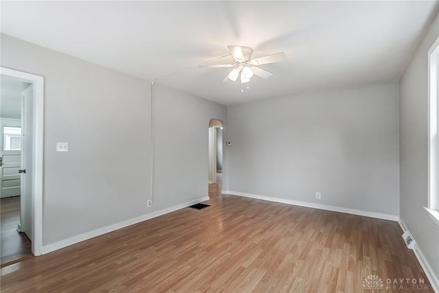 empty room featuring ceiling fan and light hardwood / wood-style flooring