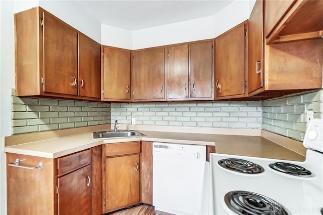 kitchen with white appliances, sink, and tasteful backsplash