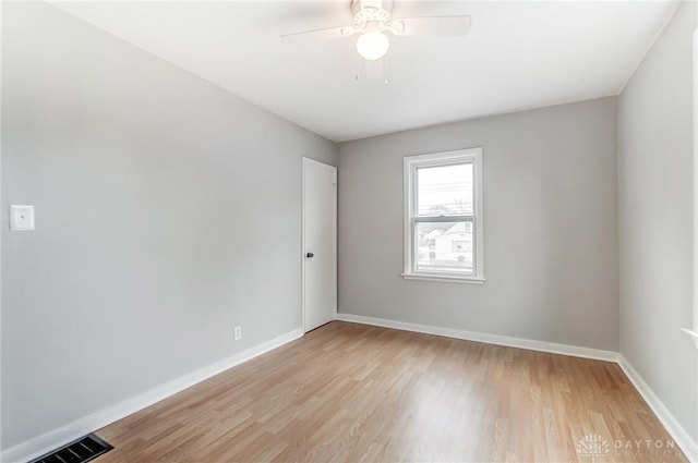 empty room featuring ceiling fan and light hardwood / wood-style floors