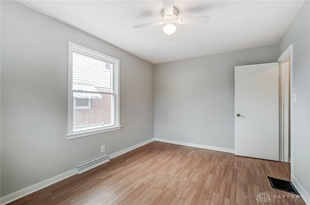 unfurnished room with ceiling fan, a wealth of natural light, and light hardwood / wood-style flooring