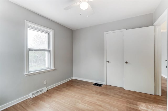 unfurnished bedroom featuring ceiling fan and light wood-type flooring